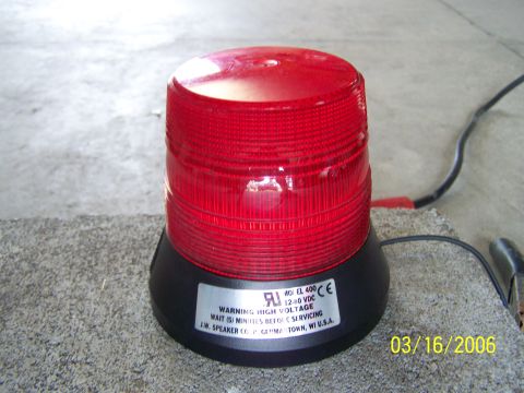 1998 Ford Crown Victoria - A red strobe warning light is shown, with text indicating high voltage and a manufacturing date.