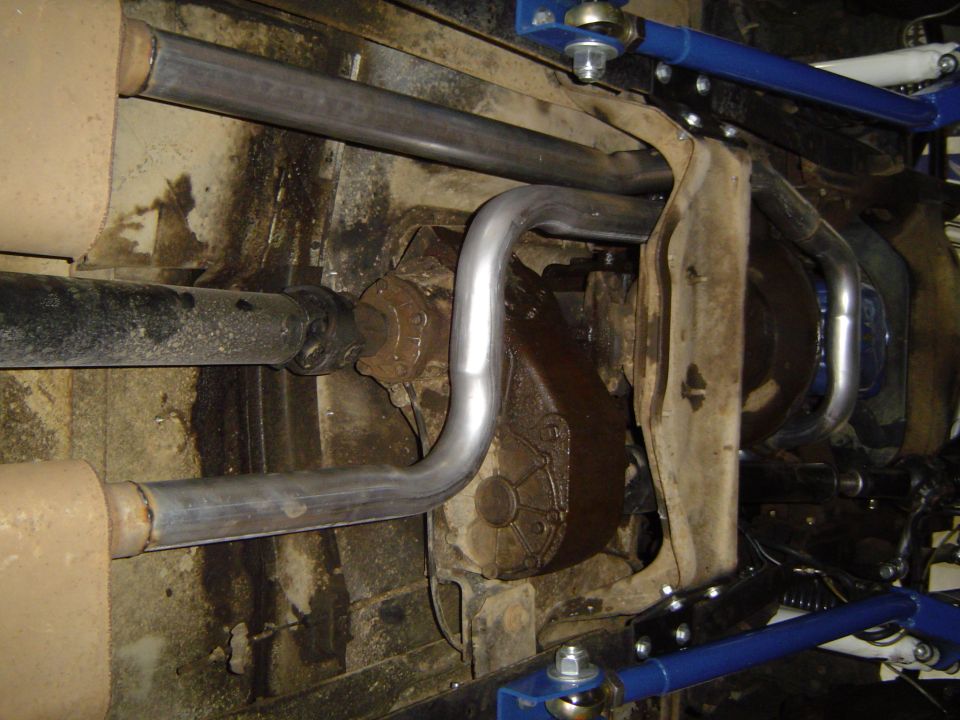 1978 Ford Bronco undercarriage showing exhaust pipes, transfer case, and driveshaft