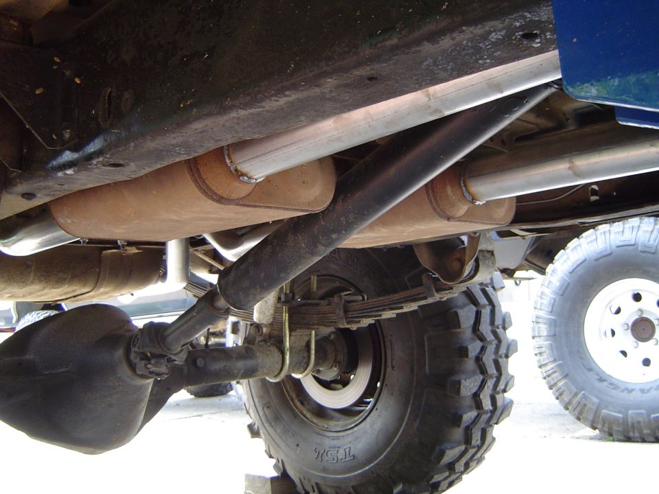 Undercarriage of a 1978 Ford Bronco showing dual exhaust and leaf springs