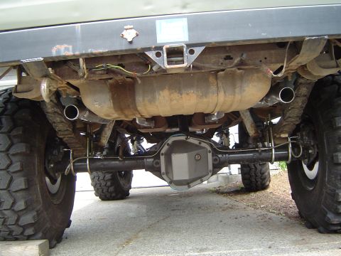 1978 Ford Bronco - Underneath view of a 1978 Ford Bronco showing the rear axle, exhaust system, and trailer hitch.