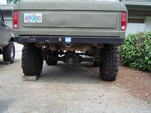 1978 Ford Bronco - This lifted pickup truck features large off-road tires and a custom bumper, with another vehicle visible to the side.