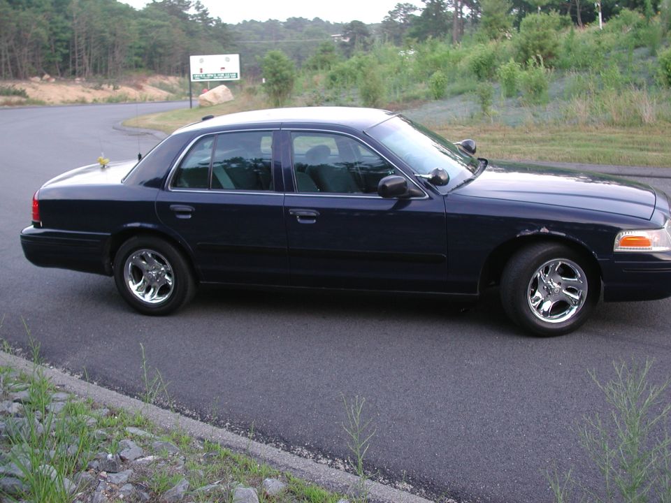 Dark blue sedan, side view. 1998 Ford Crown Victoria