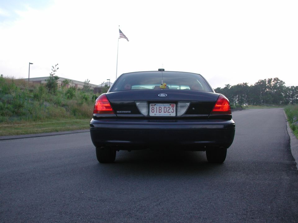 Dark 1998 Ford Crown Victoria rear view with license plate 81B D23