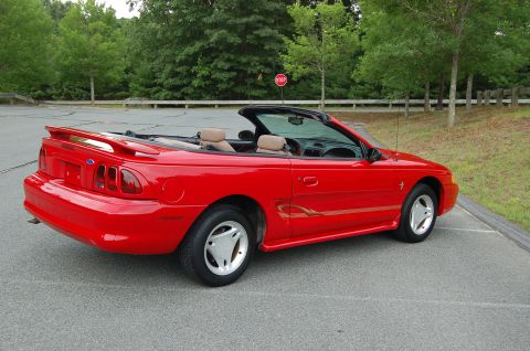 2001 Ford Crown Victoria - This red convertible Mustang features a rear spoiler and tan interior.