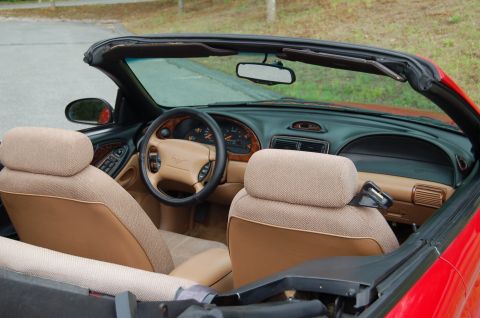 2001 Ford Crown Victoria - Interior view of a red 1996 Ford Mustang convertible, tan seats and dashboard details.
