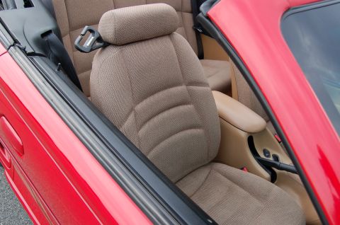 2001 Ford Crown Victoria - The tan fabric seats and center console are visible inside the red convertible.