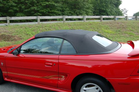 2001 Ford Crown Victoria - Side view of a red convertible, identified as a 1996 Mustang.
