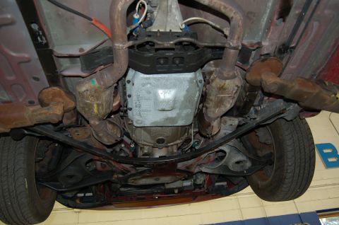 2001 Ford Crown Victoria - Underside view of a vehicle's drivetrain components, including the transmission and exhaust system.