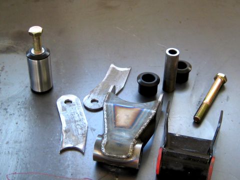 1996 Ford Bronco - Various components for a vehicle's rear suspension system are laid out on a metal surface.