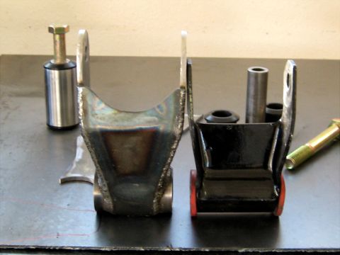 1996 Ford Bronco - Comparison of two suspension brackets, one unfinished and one painted black with new bushings.