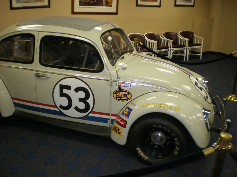 Cream Herbie-style VW Beetle racer number 53 with red and blue stripes and decals