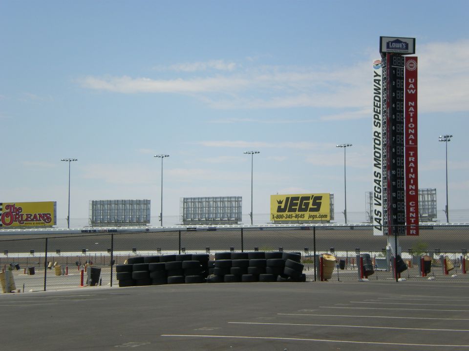 Las Vegas Motor Speedway infield with stacked SAFER barriers, tire bundles and sponsor signs