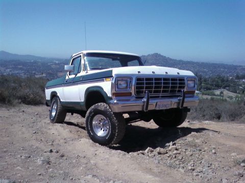 1978 Ford Bronco - This 1978 Ford Bronco is shown off-road with a clear blue sky and distant hills.