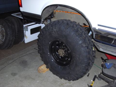 1993 Ford Bronco - Close-up of a large off-road tire mounted on a truck's rear axle.
