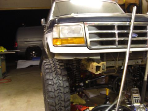 1993 Ford Bronco - Front view of a modified 1993 Ford Bronco, showing its lifted suspension and large off-road tires.