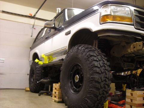 1993 Ford Bronco - Modified 1993 Ford Bronco undergoing work, large off-road tires and a lifted suspension.