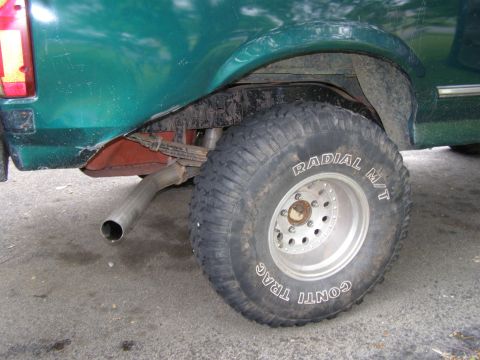 1993 Ford Bronco - Close-up of the rear wheel and suspension of a 1993 Ford Bronco.
