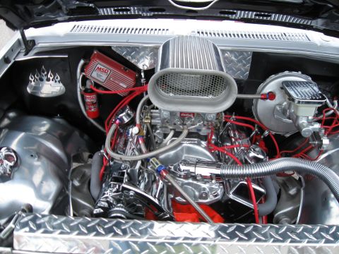 1994 Ford Bronco - The engine bay features a polished V8 engine with custom chrome accents and a prominent air intake system.