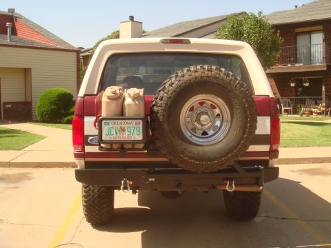 1992 Ford Bronco - The rear of a 1992 Ford Bronco shows a spare tire, two gas cans, and an Oklahoma license plate.