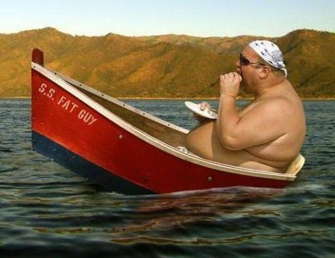 1971 Ford Ranchero - A man eats while sitting in a boat on the water, with mountains in the background.