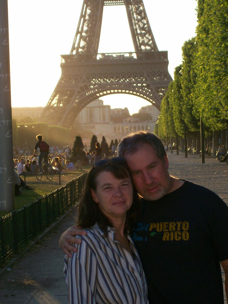 Couple posing in front of the Eiffel Tower at sunset in Paris
