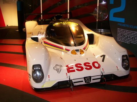 2008 Citroen Xantia - A white Peugeot 905 race car, identified by its distinctive body and 'Peugeot' text on the canopy, is displayed indoors.