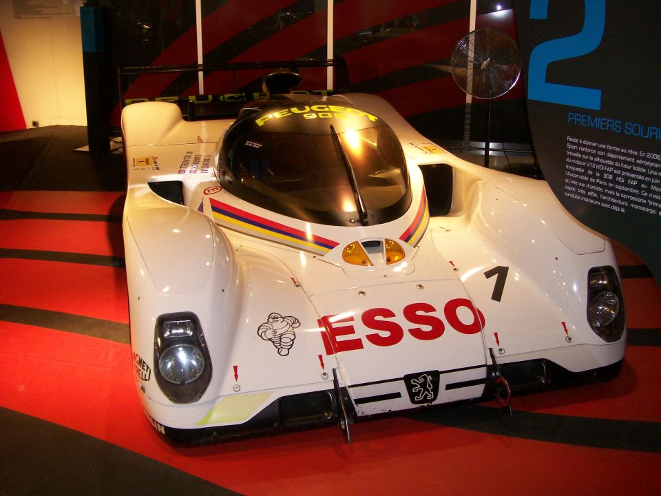 White Peugeot 908 Le Mans prototype race car with ESSO livery on display