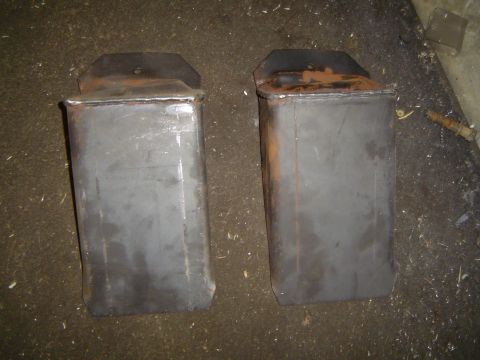 1989 Ford Bronco - Two metal boxes with mounting brackets are shown, likely exhaust system parts.