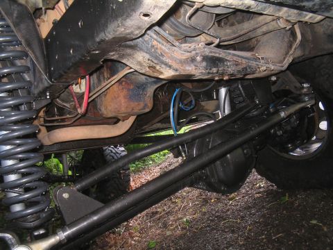 1979 Ford Bronco - Modified suspension and drivetrain components are visible from underneath the vehicle.