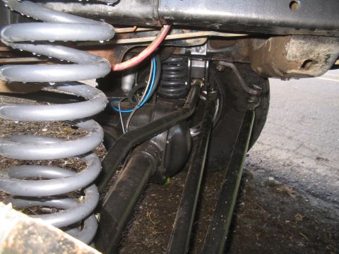 1979 Ford Bronco - This image shows the undercarriage of a vehicle, focusing on the suspension system and axle components.