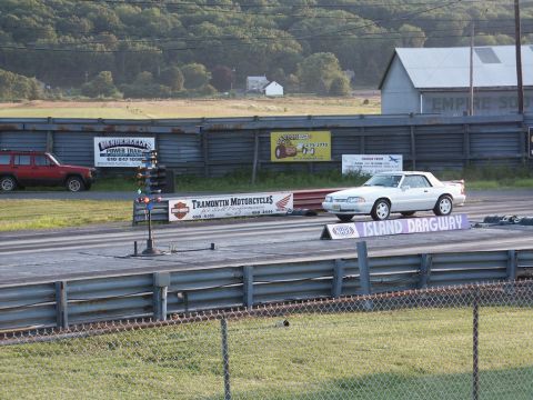 2001 Mercury Grand Marquis - A white convertible coupe is staged at Island Dragway, with a red SUV visible in the background.