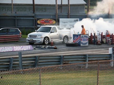 2001 Mercury Grand Marquis - A silver pickup truck performs a burnout at Island Dragway, creating a large cloud of smoke.