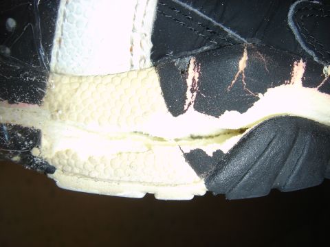 1990 Ford Bronco - The sole of a shoe is torn, revealing damaged foam material underneath.
