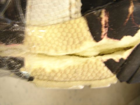 1990 Ford Bronco - The image shows a close-up view of textured car interior upholstery with a honeycomb pattern and black trim details.