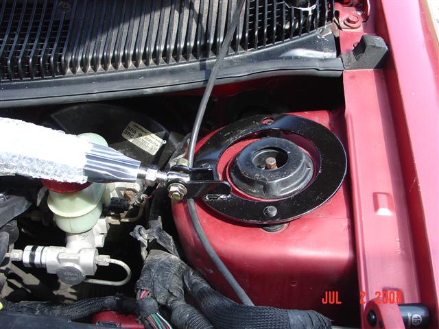 Red engine bay with strut tower brace and brake fluid reservoir