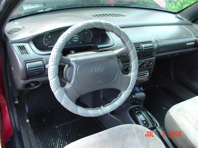 1997 Dodge Neon interior showing dashboard, steering wheel with cover, and center console
