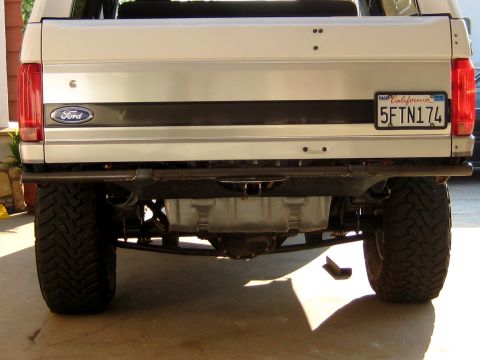 1996 Ford Bronco - The rear of a 1996 Ford Bronco is shown, a custom metal bumper and off-road tires.