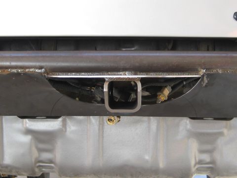 1996 Ford Bronco - Close-up view of a trailer hitch receiver and its wiring harness.