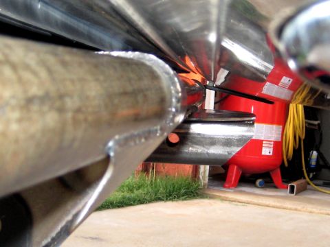 1996 Ford Bronco - A close-up view of a vehicle's rear bumper mount, with a red air compressor visible in the background.