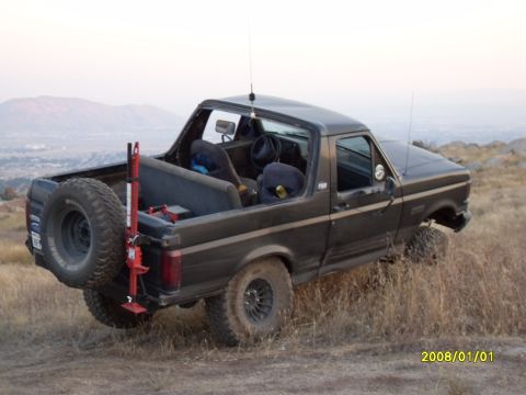 1990 Ford Bronco - This Ford Bronco is parked on a hillside with a view of the valley below.