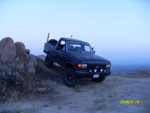 1990 Ford Bronco - This 1990 Ford Bronco is captured in a 3q-front view while navigating a rocky, off-road environment.