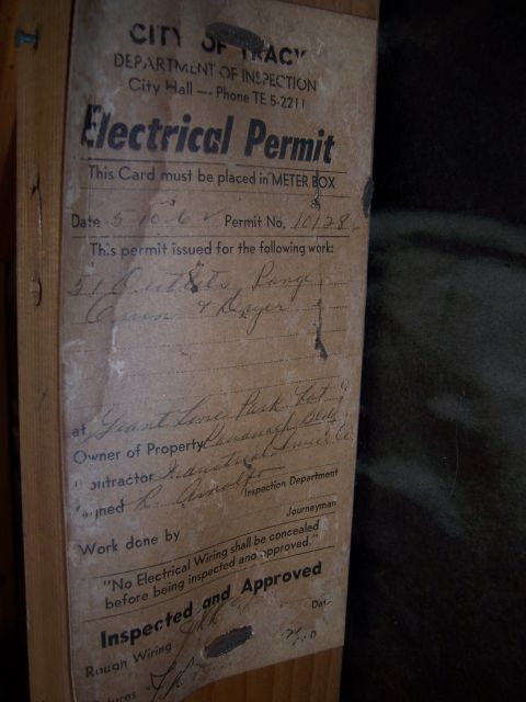 1991 Ford Bronco - Photograph of a weathered municipal electrical permit inspection card attached to a wooden post.