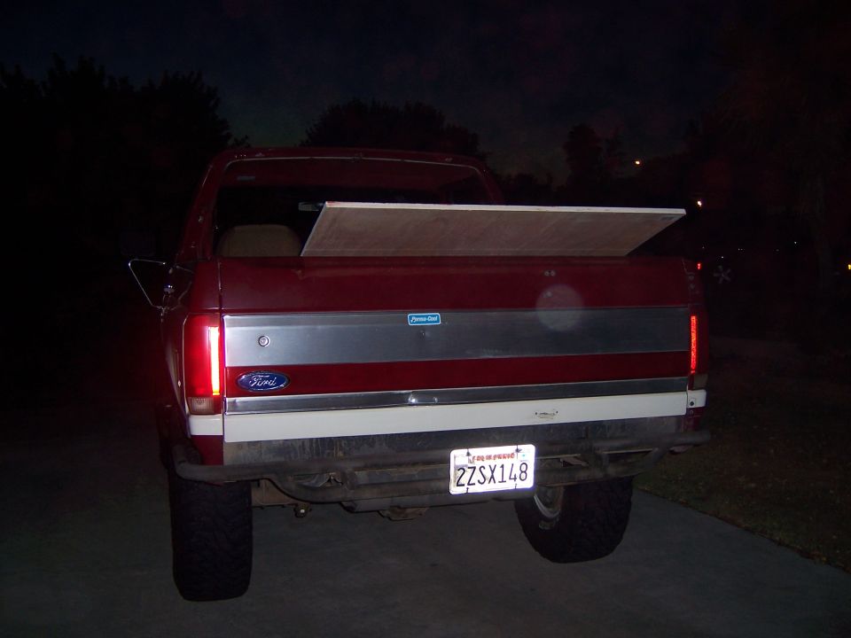 1991 Ford Bronco rear view with wood in bed and license plate 2ZSX148