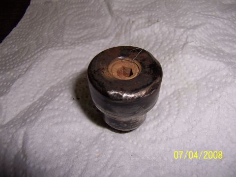 1994 Ford Bronco - A close-up view of a worn metal component with a hexagonal opening, resting on paper towels.