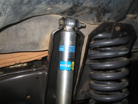 1979 Ford Bronco - Close-up view of the suspension components, including a Bilstein shock absorber and a heavy-duty coil spring.