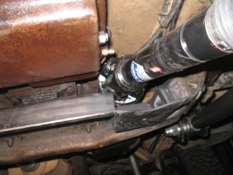1979 Ford Bronco - Close-up view of a driveshaft U-joint, showing a blue and white label with a red directional arrow.