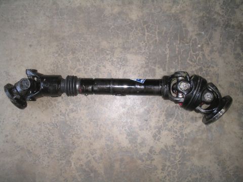 1979 Ford Bronco - A close-up view of a vehicle's driveshaft, showing its components and construction.