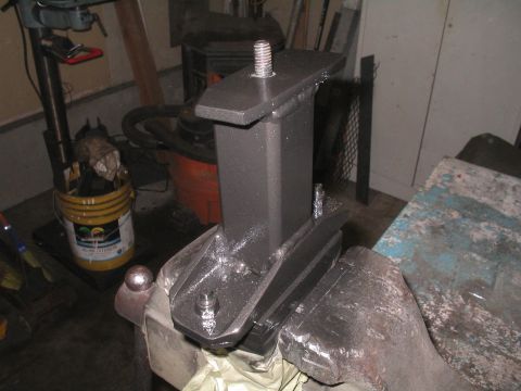 1979 Ford Bronco - A custom metal bracket assembly, likely for a vehicle modification, is secured in a vise for work.