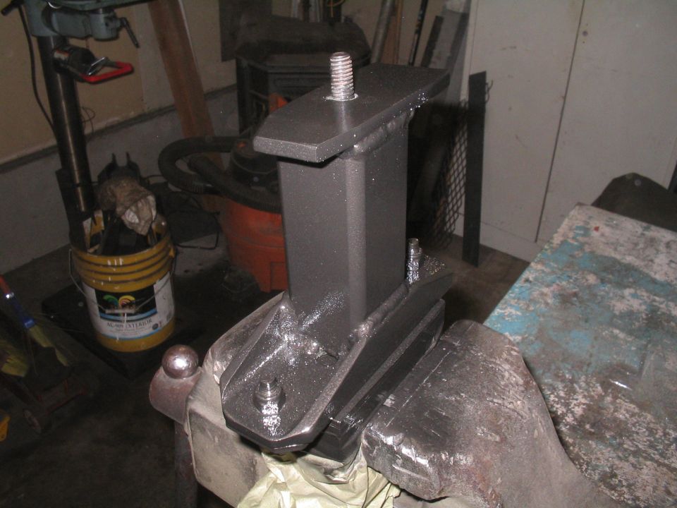 Custom metal bracket assembly clamped in a vise, with bolts and threaded rod visible