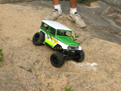 1996 Ford Bronco - A remote-controlled rock crawler toy truck navigates a challenging rocky terrain.